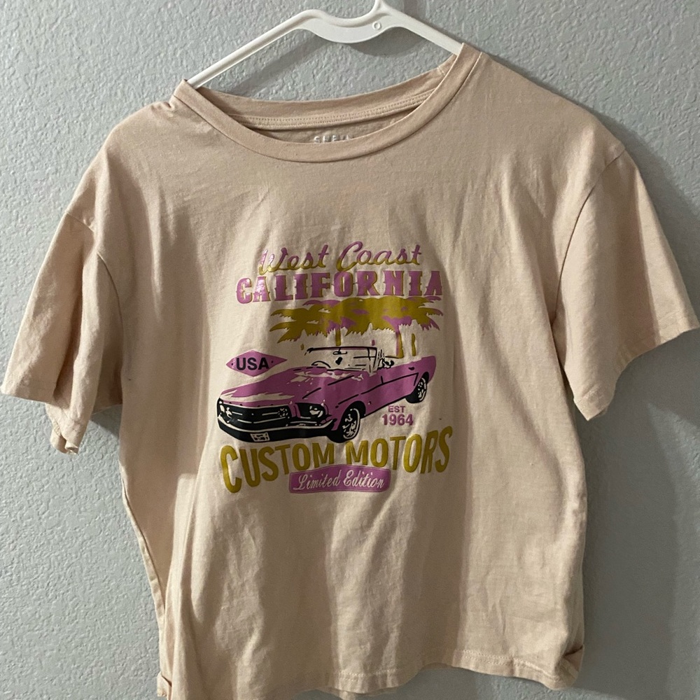 beige tshirt. loose fit. semi cropped